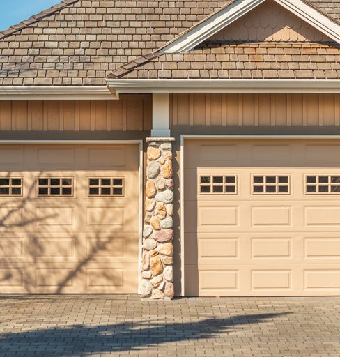 Garage door technician replacing a torsion spring in Tulsa